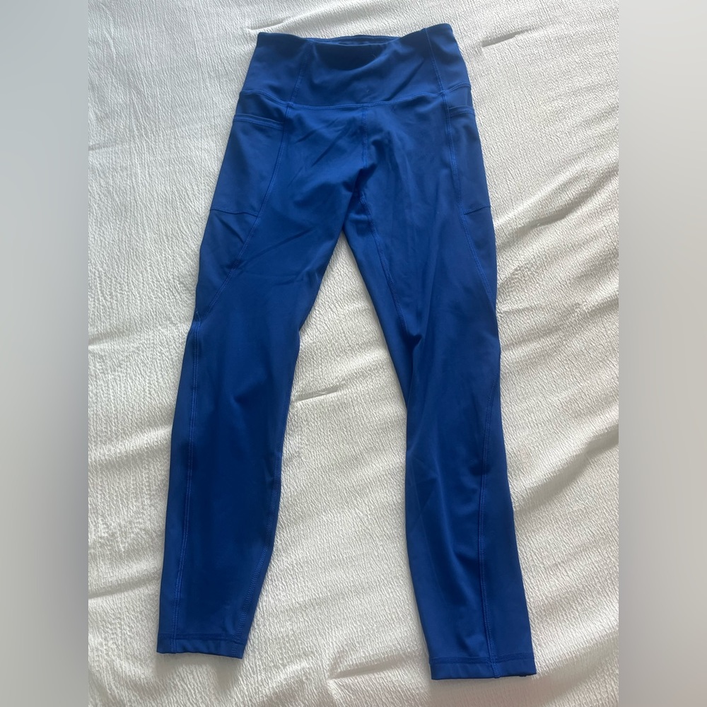 Royal blue athletic leggings with pockets on side of legs. Never worn